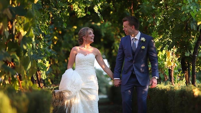 Joe and Alex walking on the vineyards of Villa Dievole. Villa Dievole wedding. The bride and groom walking on the vineyards of Villa Dievole
